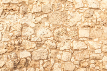 Naklejki  Tło starożytnego muru z cegły. Tekstura starego kamienia amfiteatru. Tekstura starożytnego muru z piaskowca. Wykopaliska archeologiczne
