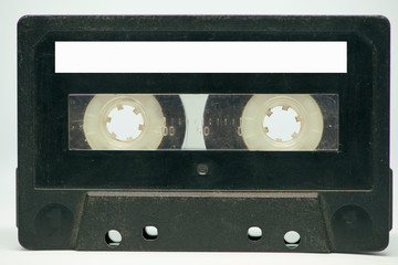A black cassette tape on a white background