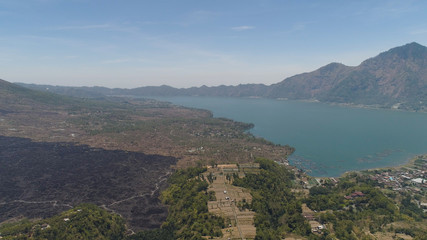 Fototapeta na wymiar Aerial view crater lake and volcano Batur mountain landscape with volcanoes, lake with sky and clouds Bali, Indonesia. Travel concept.