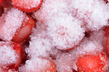 Frozen strawberries with ice crystals background pattern