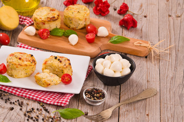 Potato gratins with mozzarella and tomatoes.
