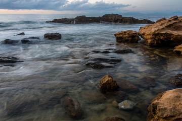 Fototapeta na wymiar Long Exposure of the Mediterranean Sea along the Southern Italian Mediterranean Coast at Sunset