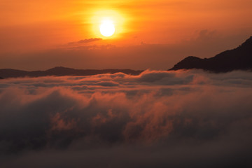 Obraz premium Beautiful dramatic sunset in the mountains. Landscape lot of fog Phu Thok Mountain at Chiang Khan ,Loei Province in Thailand.