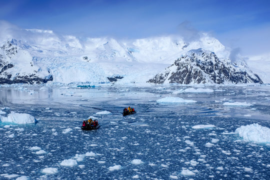 Snow, ice, glaciers, ocean water, clouds and penguins - a typical scene for Antarctica tourism