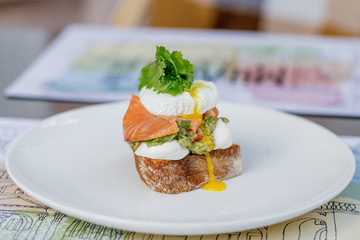 Toast with guacamole, salmon and poached egg.