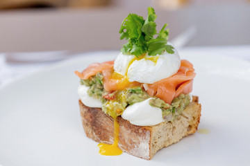 Toast with guacamole, salmon and poached egg.