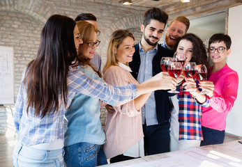 Business coworkers celebrate achieved goals in office