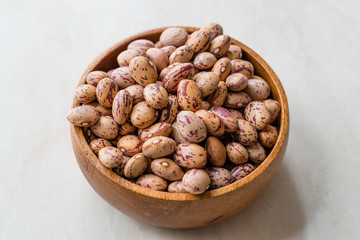 Raw Dry Pinto Beans on Marble Board with Wooden Bowl / Kidney Beans.
