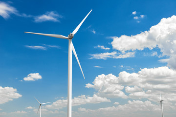 The wind generator is in bright cloudy sky. Eco energy concept.