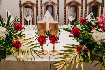 beautifully decorated banquet table for a wedding and a holiday with two glasses of champagne
