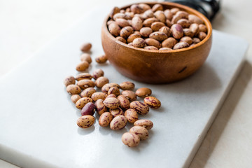 Raw Dry Pinto Beans on Marble Board with Wooden Bowl / Kidney Beans.