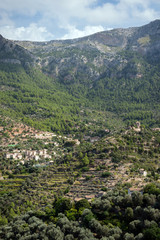 Fototapeta na wymiar Houses built on hills in small Deia mountain village in Mallorcca island, Spain