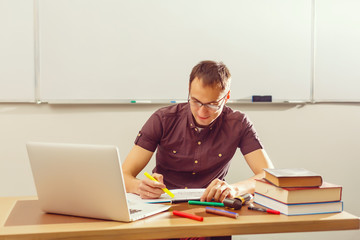 Portrait of confident Caucasian male teacher in classroom