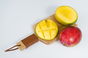 Fototapeta na wymiar mango on wooden chopping Board on white background, top view, space for text