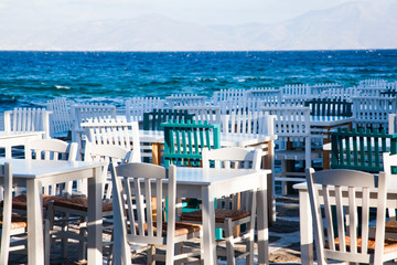 Fototapeta na wymiar restaurant chairs and tables by the sea