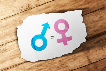 Symbol of male gender is equal to female in white paper on wooden table