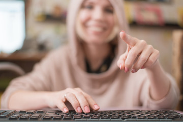 A woman draws a finger in the air like on a computer monitor. View from the side of the screen. The...