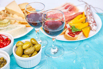 Italian antipasti wine snacks set. Brushettas on blue background.