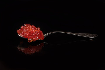 red salmon ROE on black background