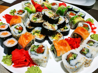 Set of different types of rolls on a white plate. Traditional Japanese Dish