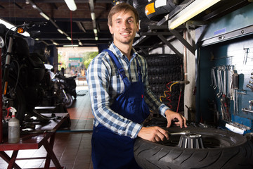 young male mechanic working in auto repair shop