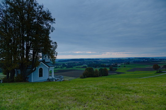 View over the Isental in Bavaria in the morning with a small chapell in the foreground