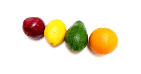 Exotic fruits - orange, lemon, avocado and pomegranate - close up isolated on white background