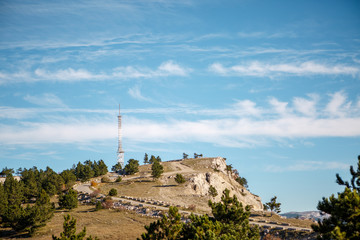 Fototapeta na wymiar Photo of mountainous area, road, tower, blue sky