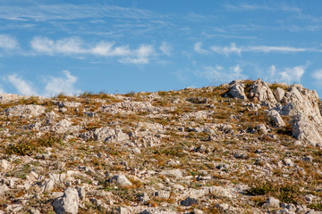 Photo of mountain area with grass, blue sky