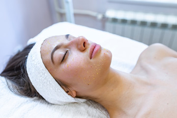 Needle mesotherapy in beauty spa salon or clinic. Cosmetics been injected to woman's face, close up...