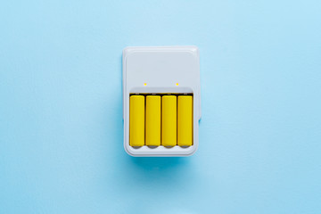 Photo of charger with yellow batteries