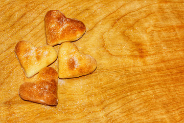 Delicious cookies with hearts on a wooden Board