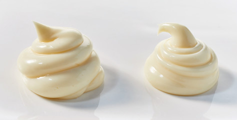 Two decorative twists of creamy mayonnaise