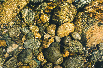 Stones in mountain river under water