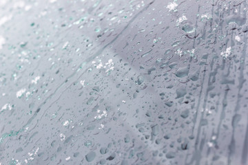 Snow and raindrops on glass as background.
