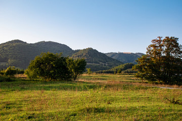Fototapeta na wymiar view on hills from green meadow