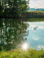 Fototapeta na wymiar sun reflection on the lake in the summer