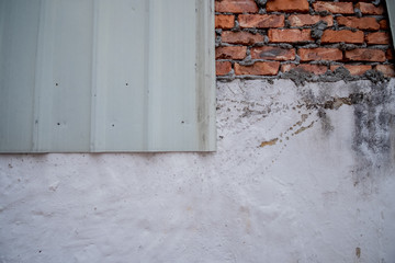 Combine of red old brick wall on the top white background on the bottom white zinc paste on the wall 