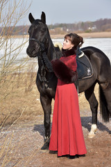 woman in vintage  suit with  horse