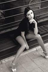 portrait of a young beautiful brunette woman on the street, model posing, women's urban street...