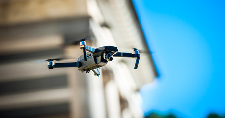 Drone quadcopter with digital camera. Against the sky