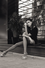 portrait of a young beautiful brunette woman on the street, model posing, women's urban street...
