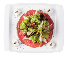 Mix salads on meat carpaccio with Philadelphia cheese. On a white background
