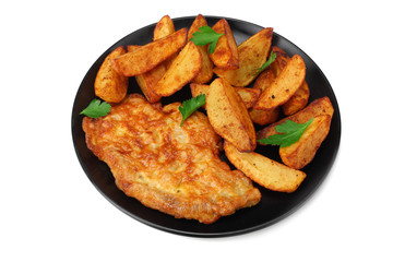 Fried potato wedges with schnitzel on black plate isolated on white background
