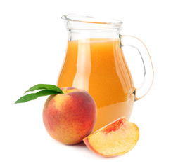 jug of peach juice with peach fruit and slices isolated on white background.