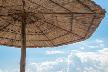 straw beach umbrella clear day blue sky summer