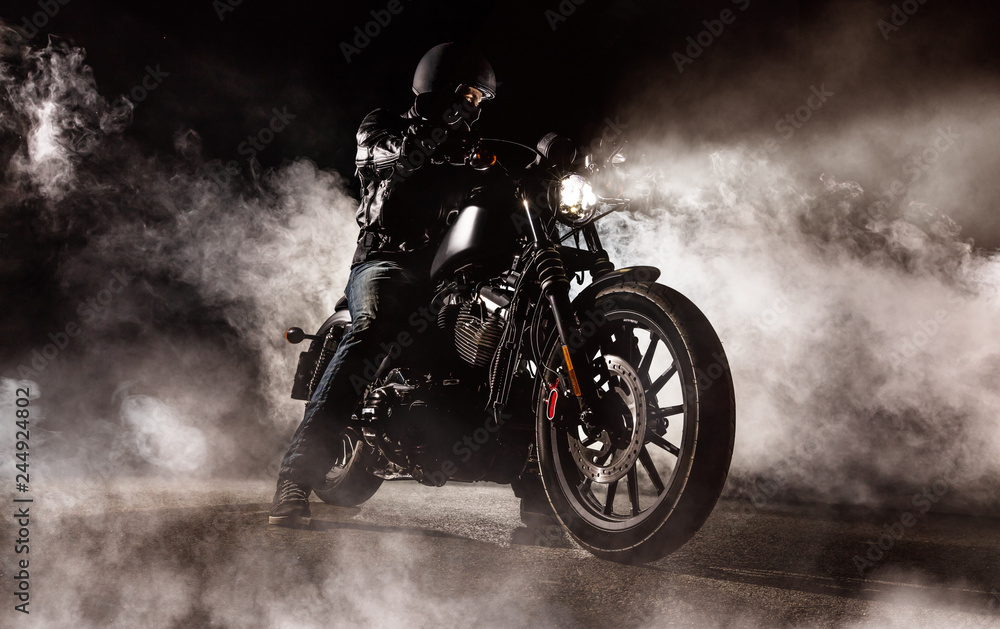 Wall mural Dark motorcycle driver in fog