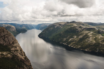 View on Preikestolen and swirl of motor boat in fjord