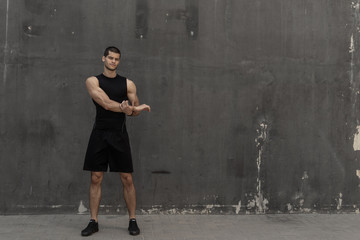 Strong muscular, sporty man warming up, getting ready for training