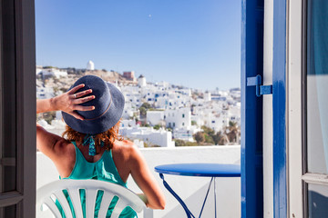 woman enjoying mykonos town view from terrace, Greece - summer holiday - obrazy, fototapety, plakaty